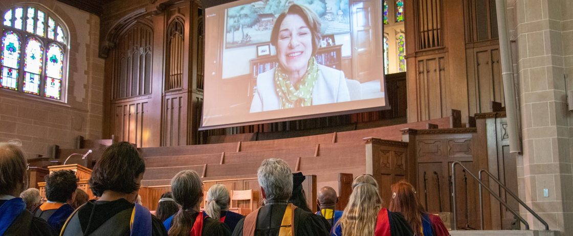 US Senator Amy Klobuchar appears on a large video screen at Opening Convocation 2022
