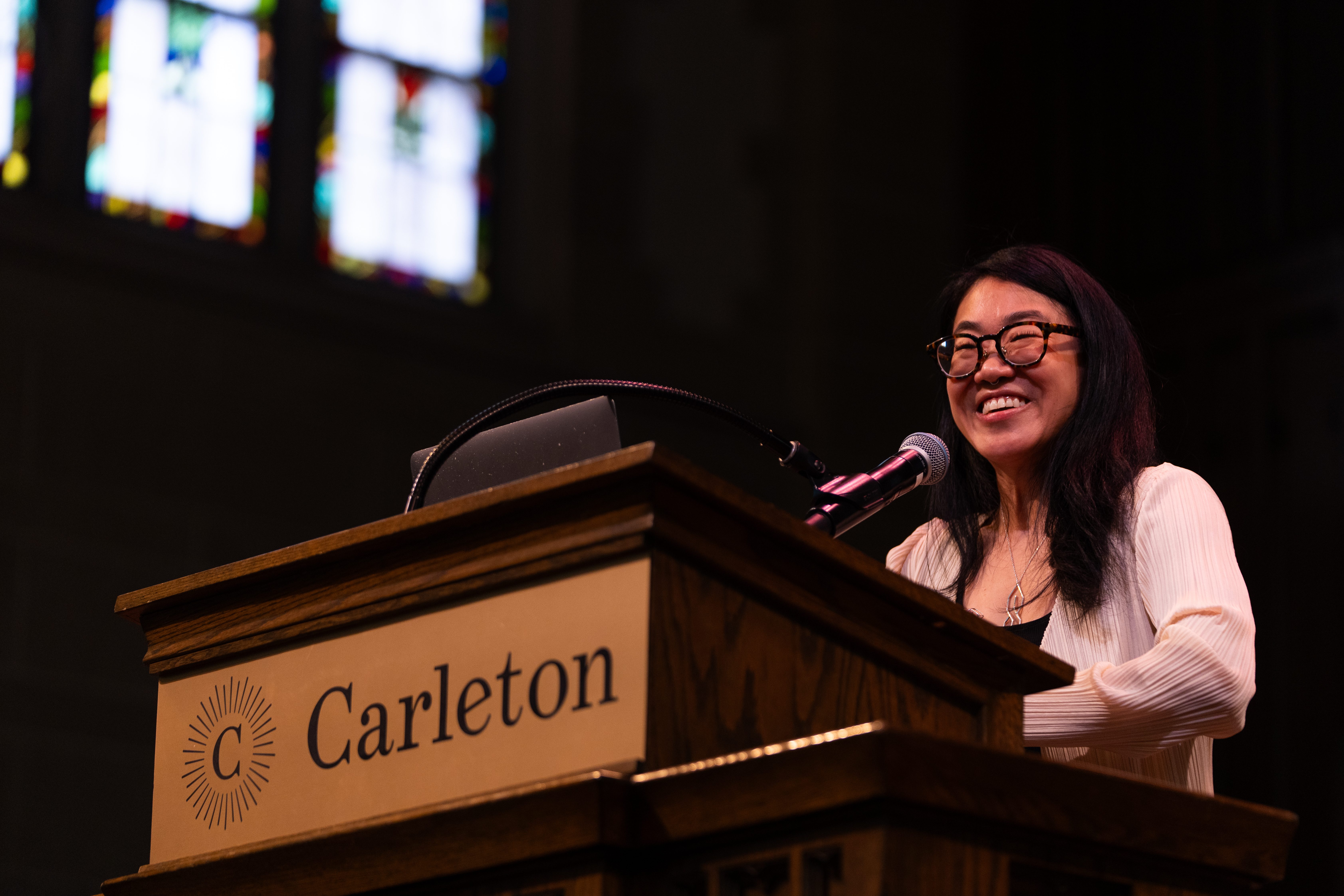 Wyna Liu giving her Convocation presentation at the podium.