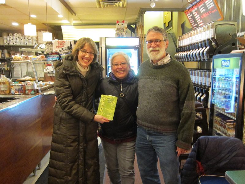 Brigid, Teri and Mark posing with Practical Chinese Reader Text