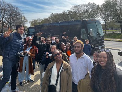 Carleton students outside their tour bus in Washington, DC