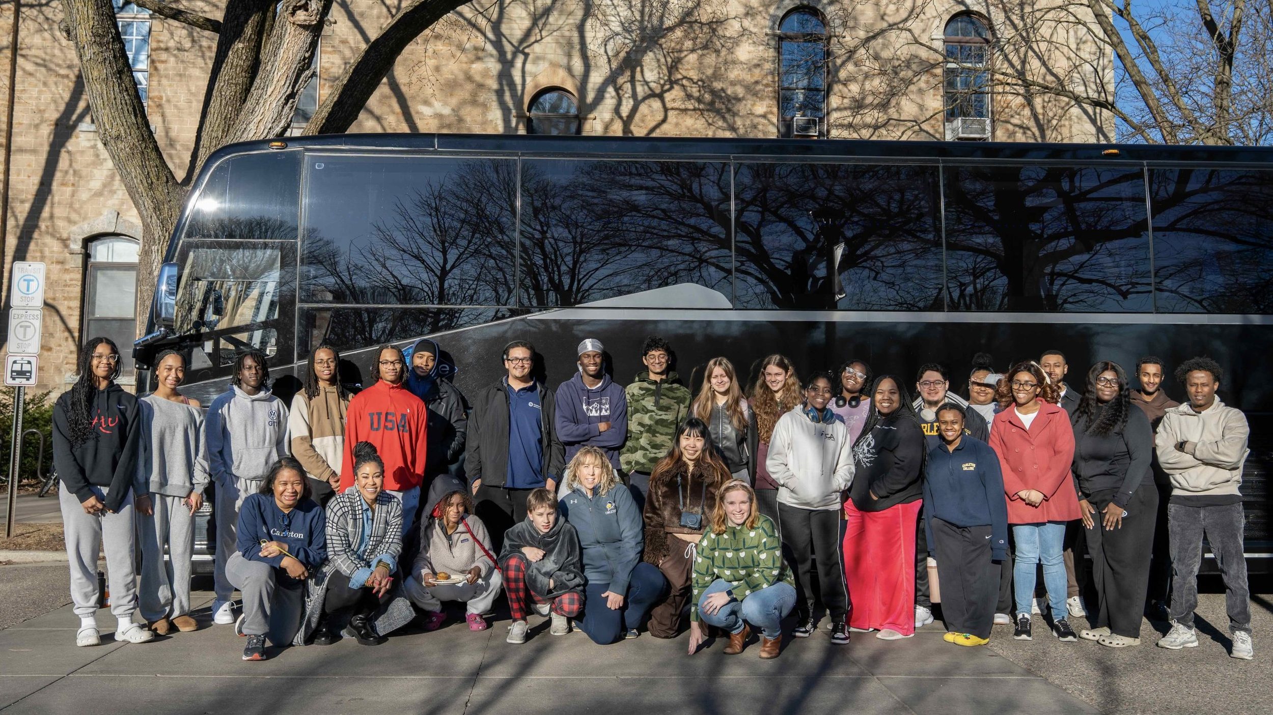 Participants in the 2025 Northfield to Selma trip pose for a photo in front of their tour bus