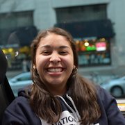 A student on a bus, smiling