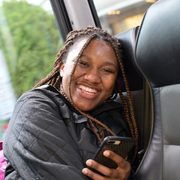 A student on a bus holding a mobile phone