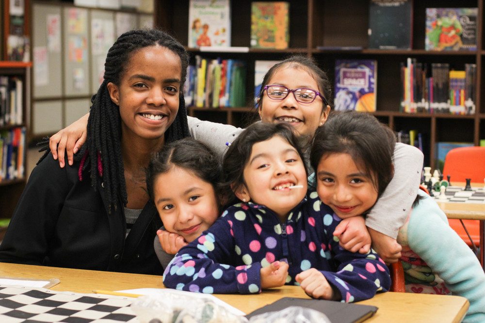 Jessica Makori '19 (Bloomington, Minn.) poses with her homework help students at Greenvale.