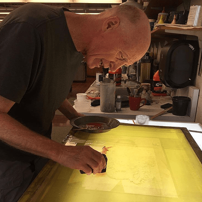 Fred toils over a screen for a print this summer.