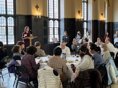 Community Partner Appreciation with guests seated at tables listening to Sinda Nichols