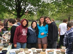 individuals pose for a photo at empty bowls event