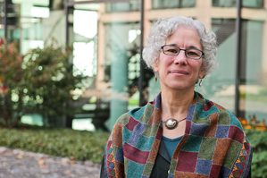 Carleton faculty member wearing shawl outside a glass building