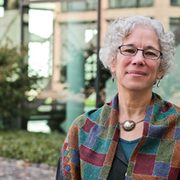 Carleton faculty member wearing shawl outside a glass building