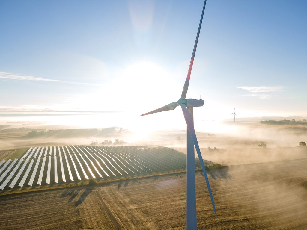 foggy morning of the wind turbines and solar panels