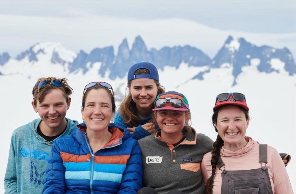 group photo in front of snowy mountains