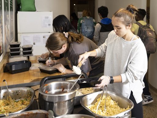 Student packaging up food as part of a Food Recovery Network effort