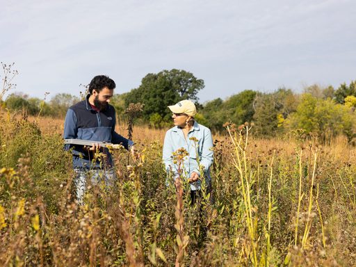 Carleton College Arb Director Nancy Braker talking to a student while looking at native plants in the Arb