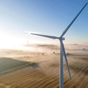 Wind turbines and solar panels on a foggy morning
