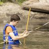 Carleton student measuring river water flow in Cannon River