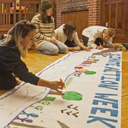 Students create an enormous colorful banner to celebrate Carleton's Climate Action Week