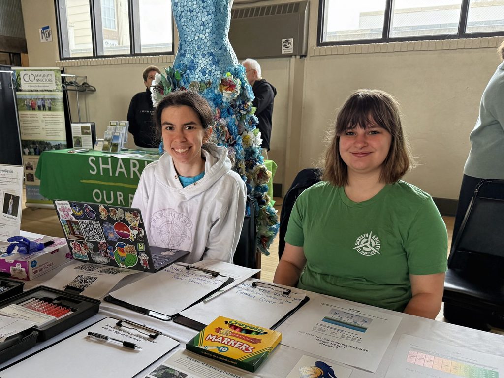 students seated at information table