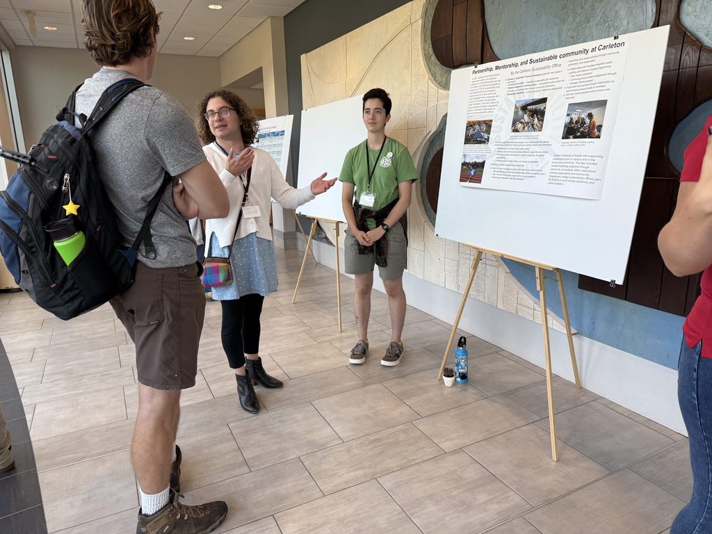 students share a poster presentation