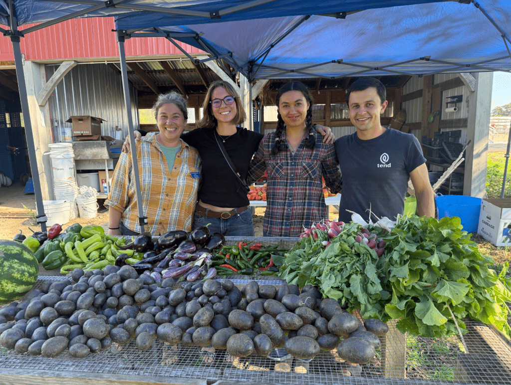 Amanda Sames, Maeve Clover, Meagen Roesler, and Daniel McGovern pose with produce haul