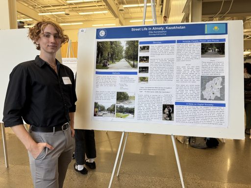 Ellis with their poster at the symposium