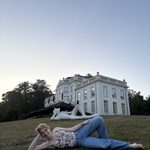 Erin Mattingly poses in front of sculpture and bilding