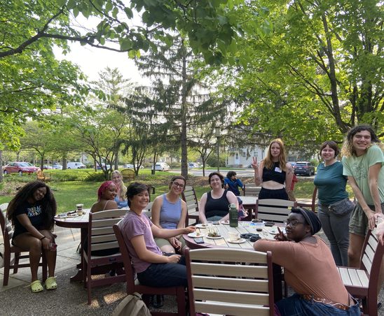 GWSS students and faculty posing for a group photo on the AGH patio at the spring '23 Strawberries & Chocolate Celebration.
