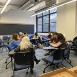 A group of GWSS students enjoying pizza in a Leighton classroom at the winter '24 Pizza Party.