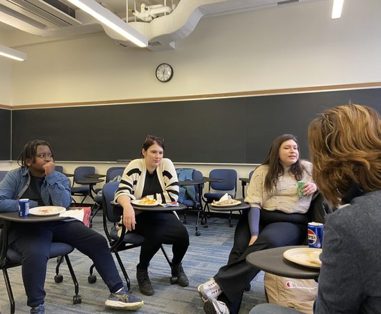 GWSS students and faculty conversing at the winter '24 Pizza Party.