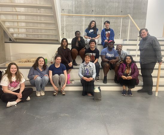 GWSS students and faculty posing for a group photo in the Weitz basement at the spring '24 Strawberries & Chocolate Celebration.