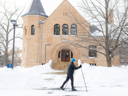President Alison Byerly cross-country skiiing to campus in a winter storm