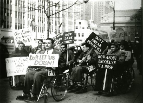 Protesters in wheelchairs on the sidewalk