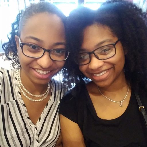 two sisters pose for a photo