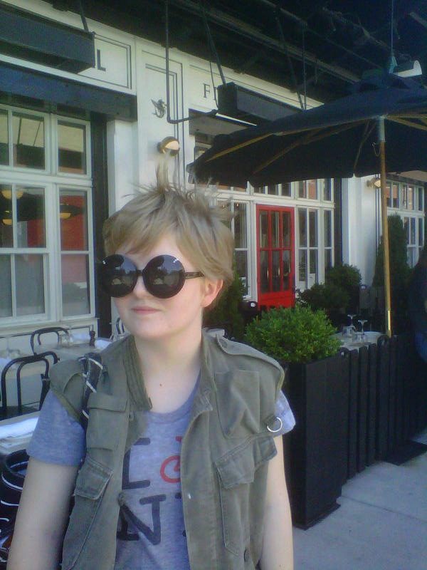 Student wearing sunglasses at a sidewalk café