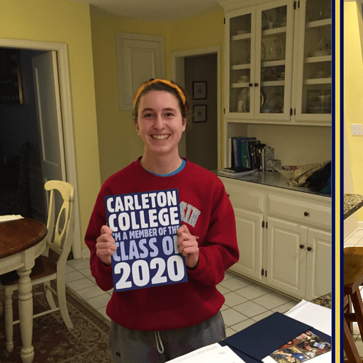 student holding carleton signs