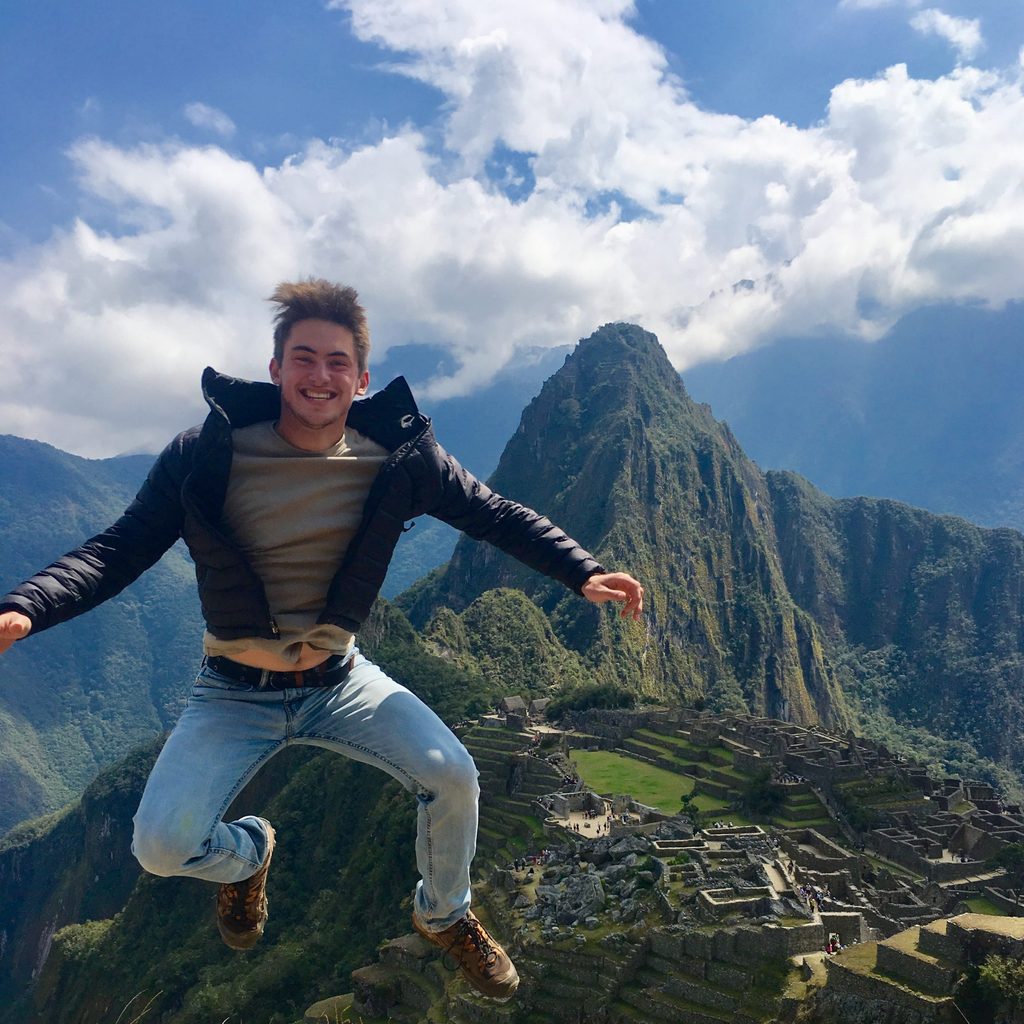 Young man jumping in the air on a mountaintop
