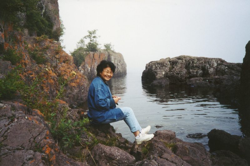 Mariko sitting along Lake Superior cove.