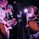 student band playing guitar on stage