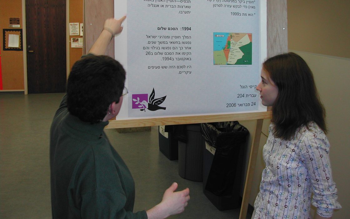 a professor and a student looking at a research poster