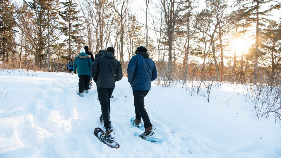 Students snowshoe in the arb