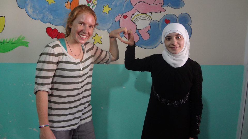 Ulbricht posing with a young teacher at the Reyhanli children's center