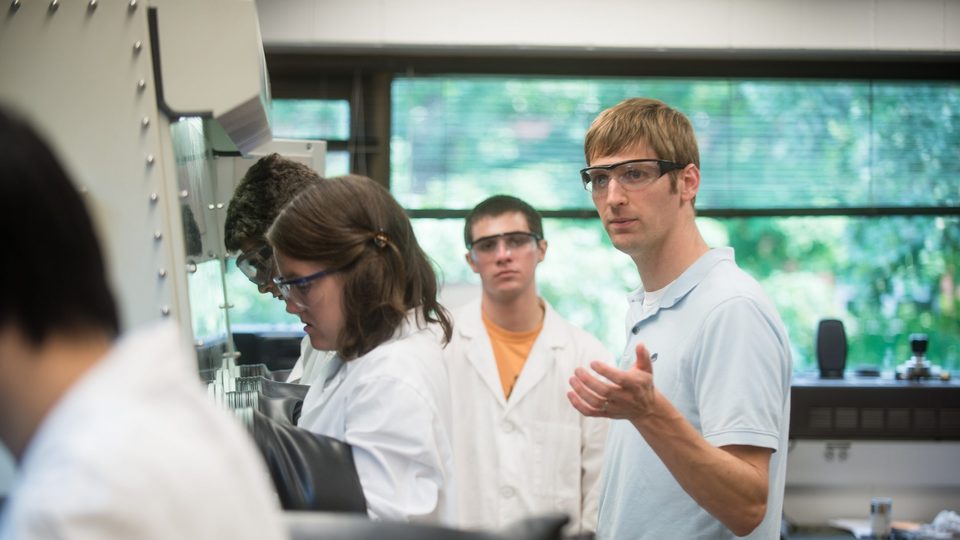 Matt Whited watches over students in the Carleton science research lab.