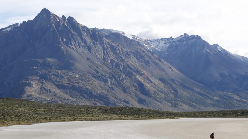 Backdrop of the Patagonian mountains framing a lone hiker