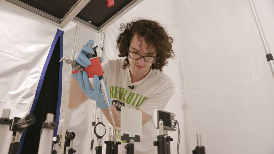 Image of Sam Stevenson '19 working in the lab on his polymer lens research.