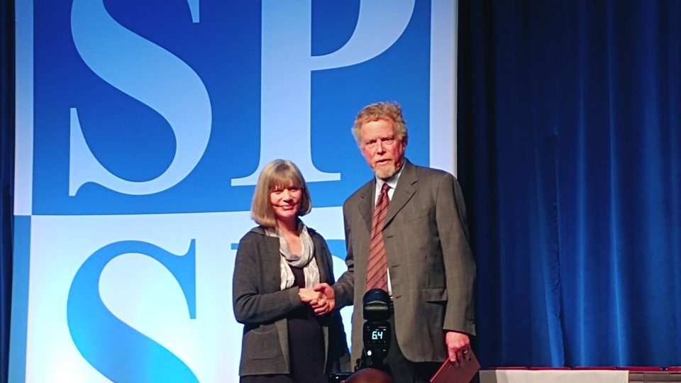 Image of professor Neil Lutsky receiving award.