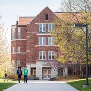 Students walk on campus in the spring.