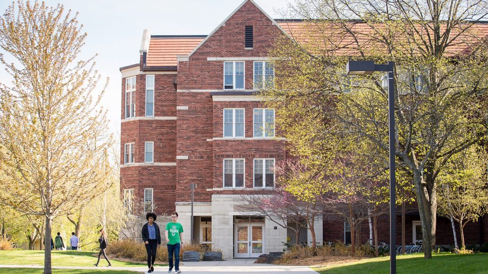 Students walk on campus in the spring.