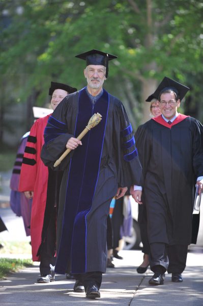 College Marshal John Schott leads President Steve Poskanzer and Convocation speaker Jimmy Kolker towards the Chapel for Opening Convocation.