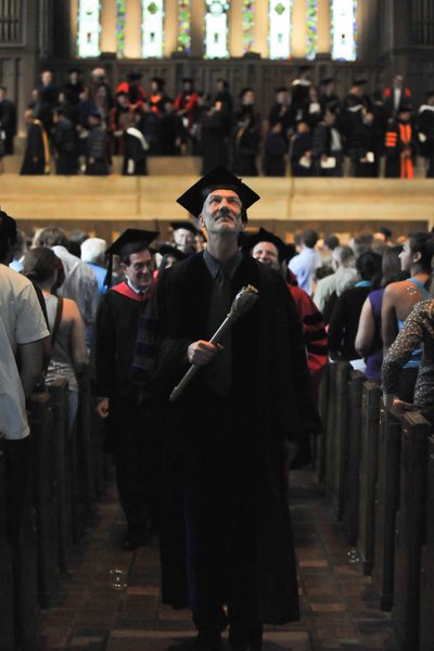 Bubbles rain down from the upper level of the Chapel as the College Marshall John Schott leads the faculty, administration, and staff out of the Chapel.
