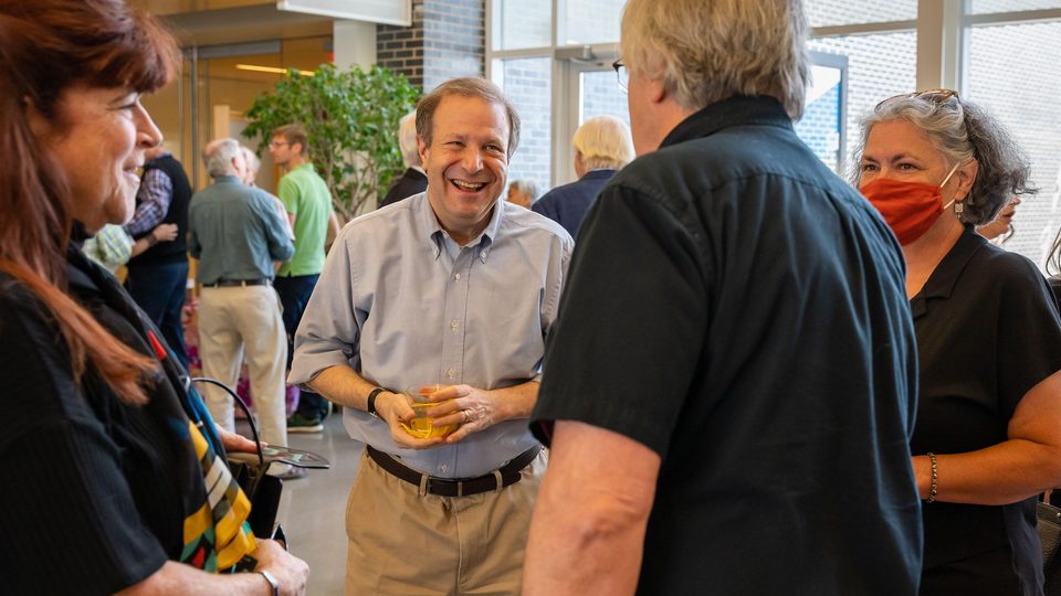 Steve Poskanzer, center, at a reception held in his honor.