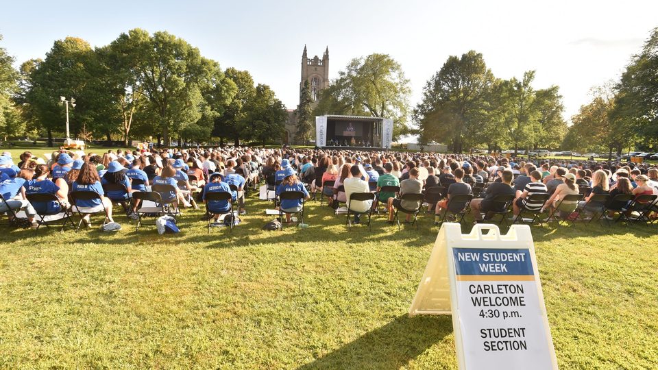 wide shot of the Carleton Welcome student section with the Class of 2025 and the chapel in the background